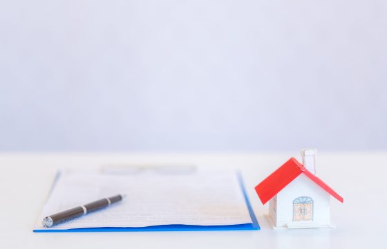 Small houses modern design and documents with pen on white background for home loans concept